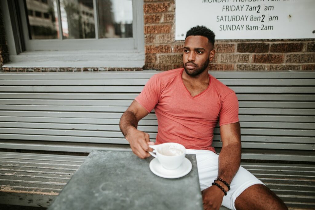 man sitting outside cafe