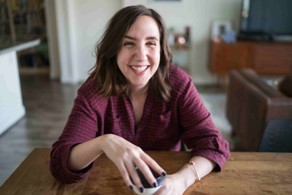 young woman laughing with coffee