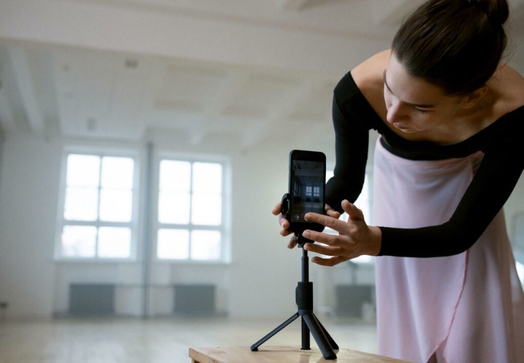 ballerina setting up phone on tripod