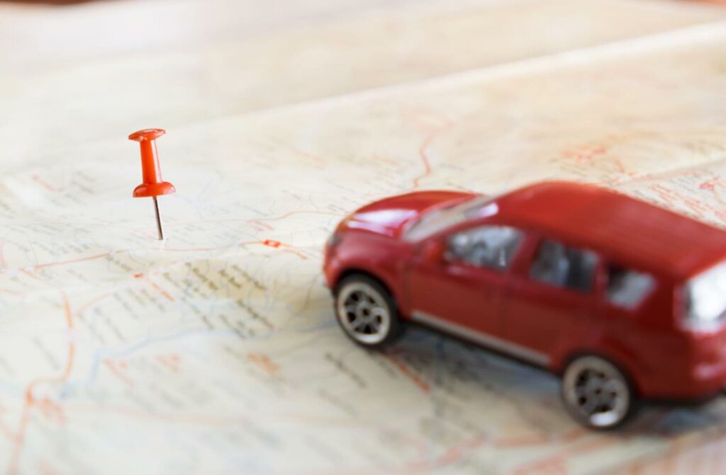 toy red car with map and pin