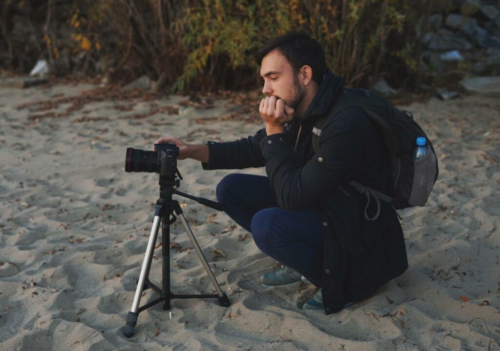 man with camera on beach