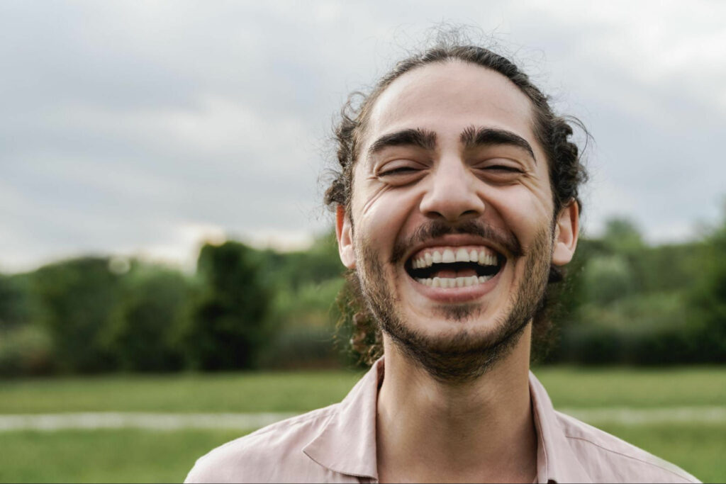 smiling man with curly hair