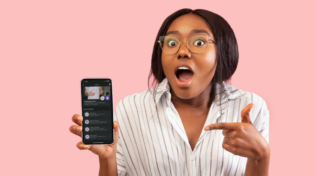 pink background with woman looking surprised and pointing at her phone