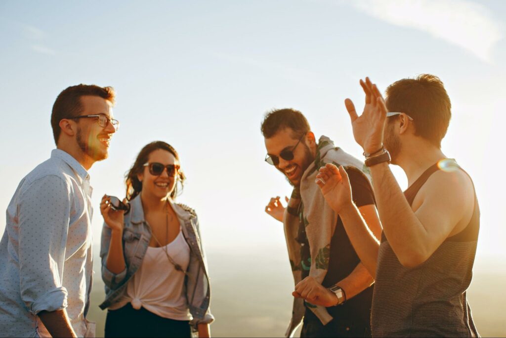 four friends laughing and talking in a circle