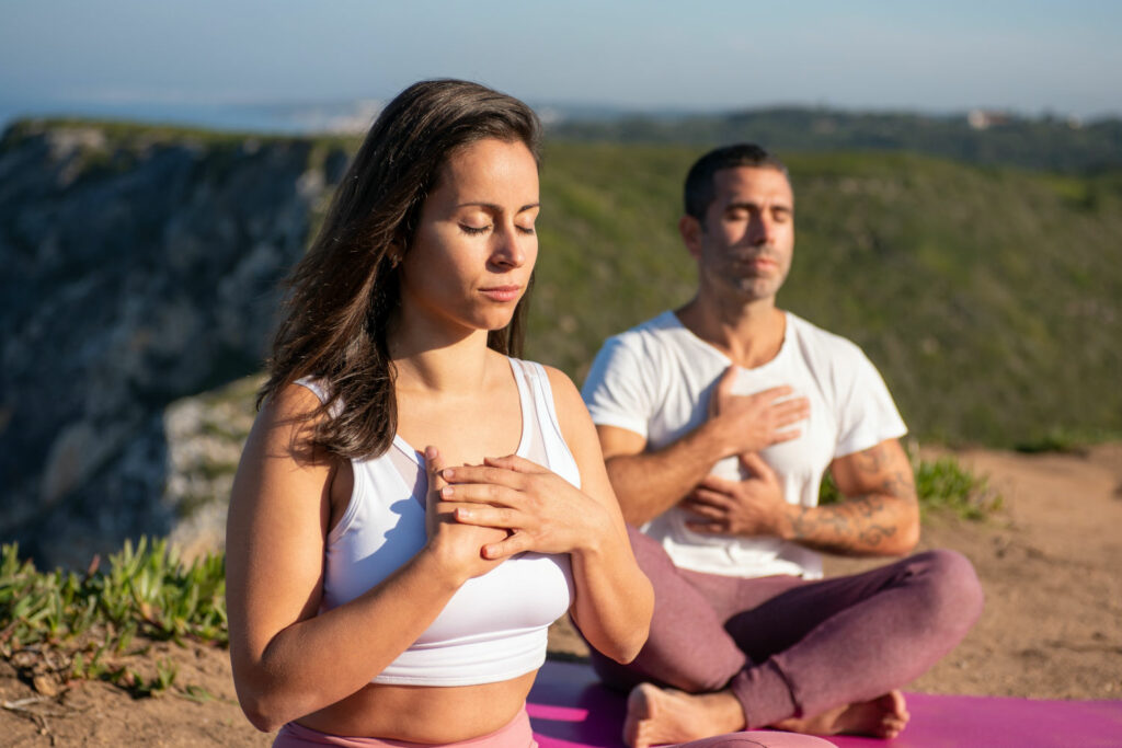 woman and a man doing tantric yoga on mountainside, tantric speed dating