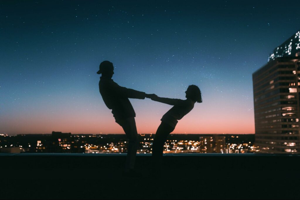 cute couple spinning around under the stars
