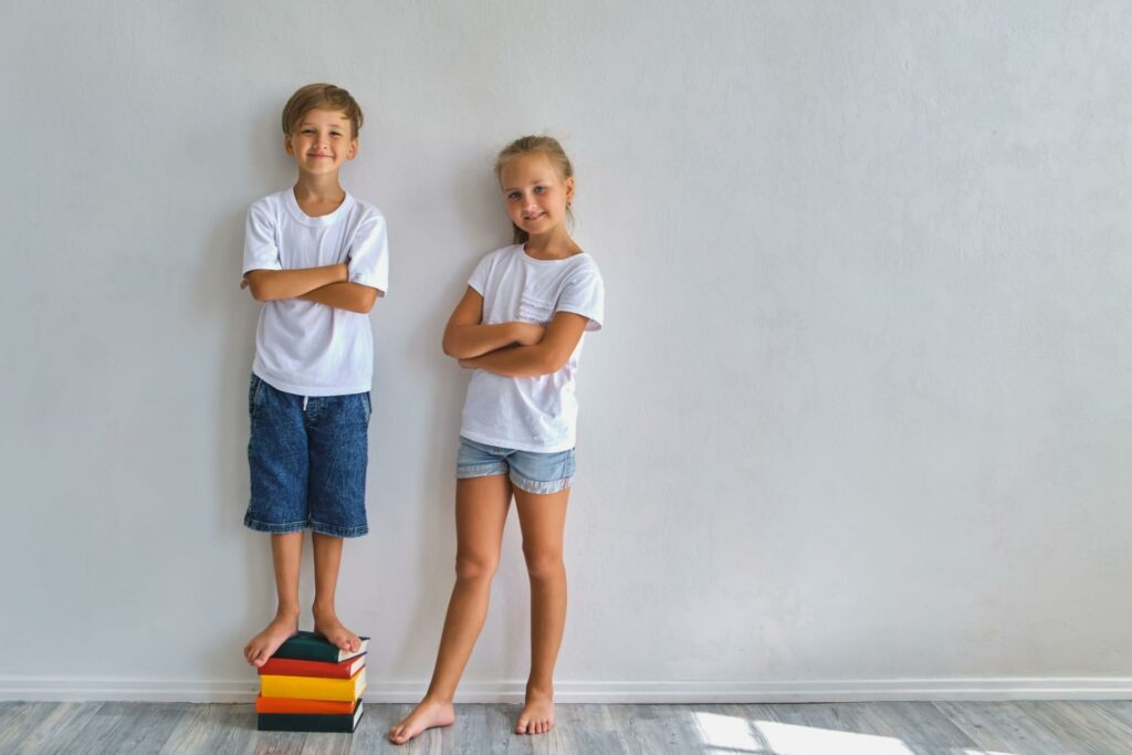 children smiling cross arms