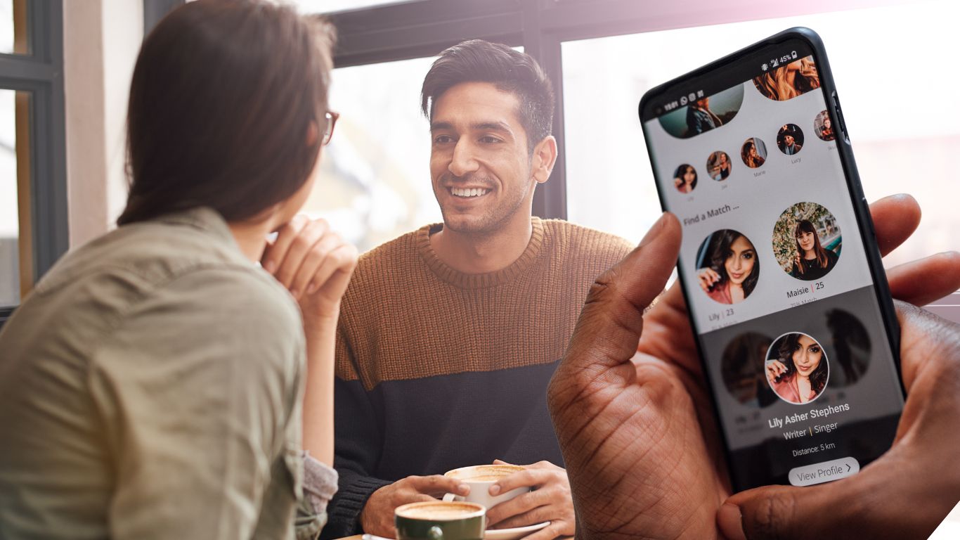 man and woman on cafe date with hand with phone on dating app