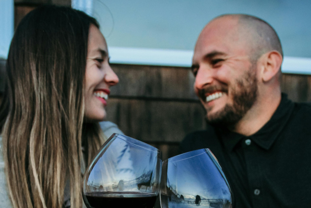 Elite singles, two people on a date, sharing wine