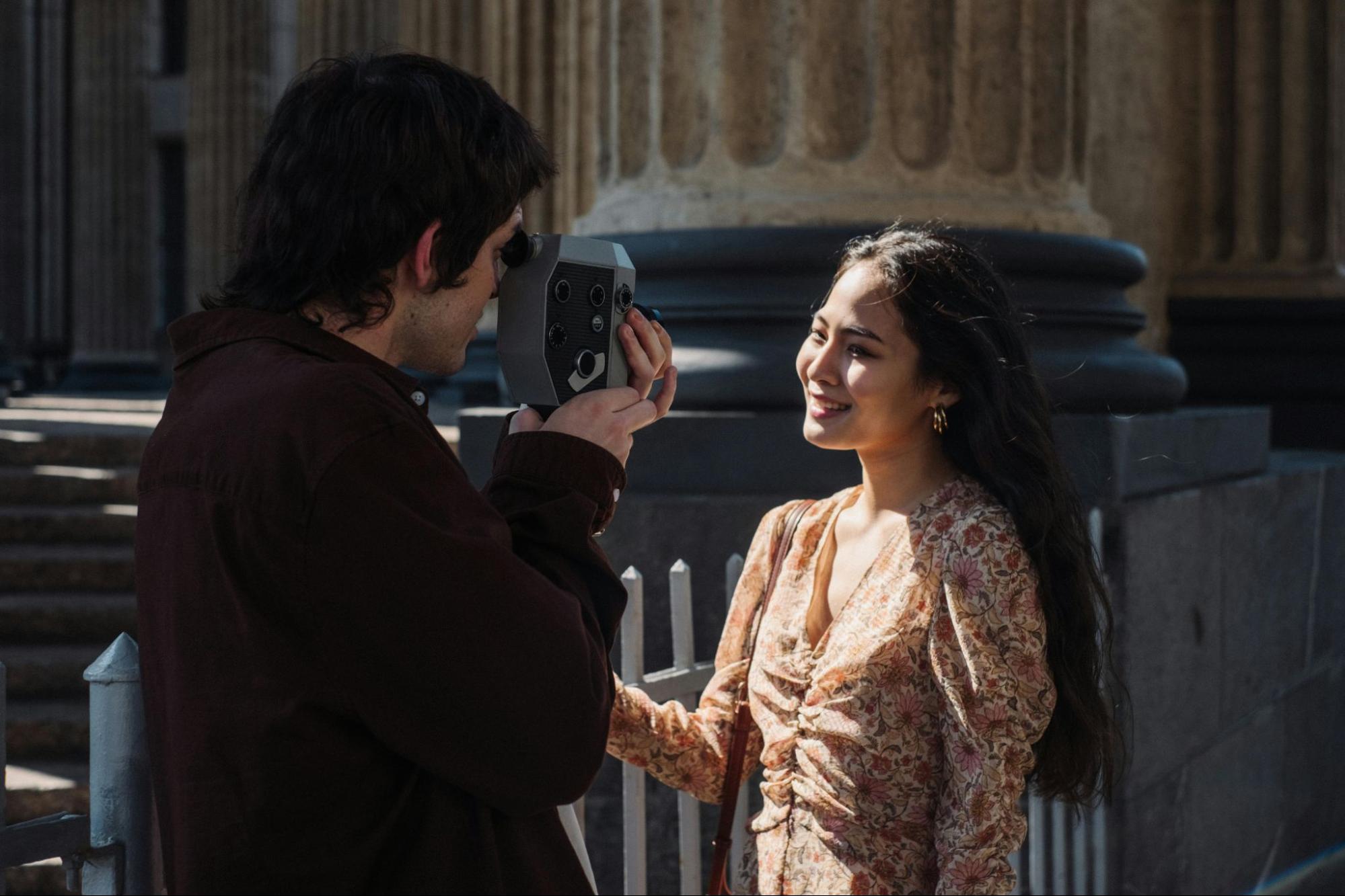 Man taking a photo of smiling woman for dating apps