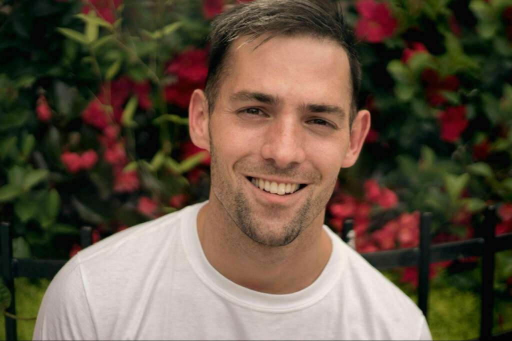 man smiling into camera, portrait for online dating profile