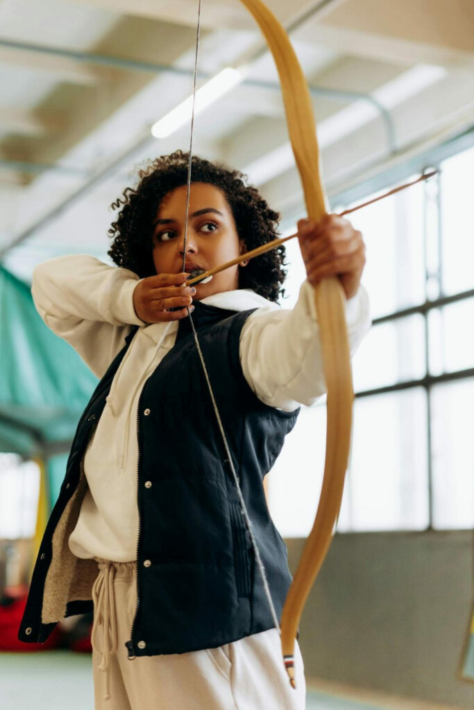 woman shooting an arrow, online dating hobby photo example