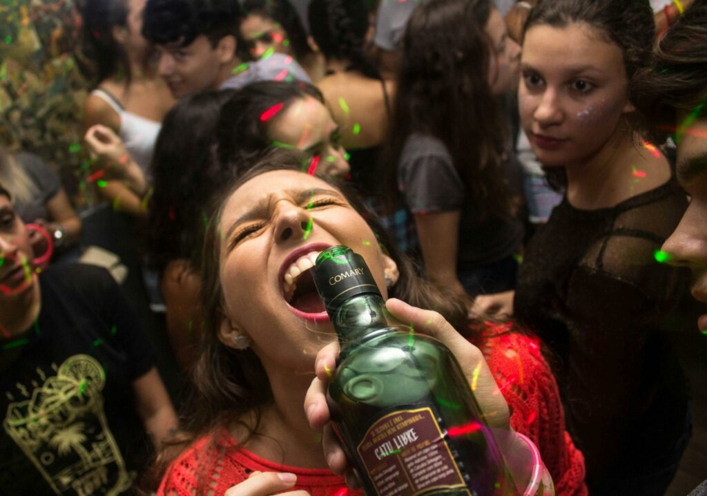 drunk girl at a party drinking alcohol