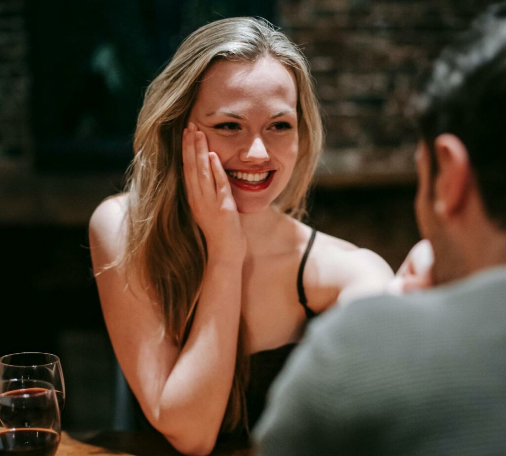 woman smiling at her date in a restaurant