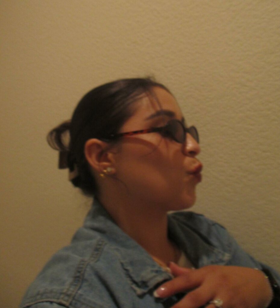 woman taking a blurry side selfie