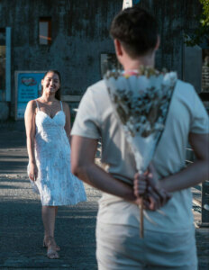 man bringing flowers to a woman for a surprise on a date
