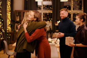 woman hugging her partners family at cafe