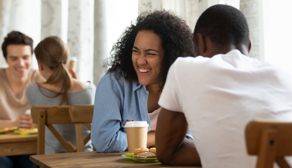 couple laughing at a speed dating event, speed dating in person event