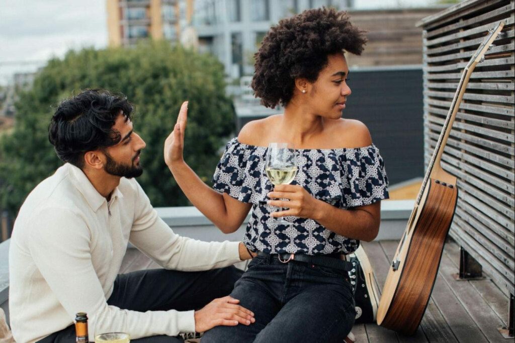 woman putting up her hand to stop conversation on date