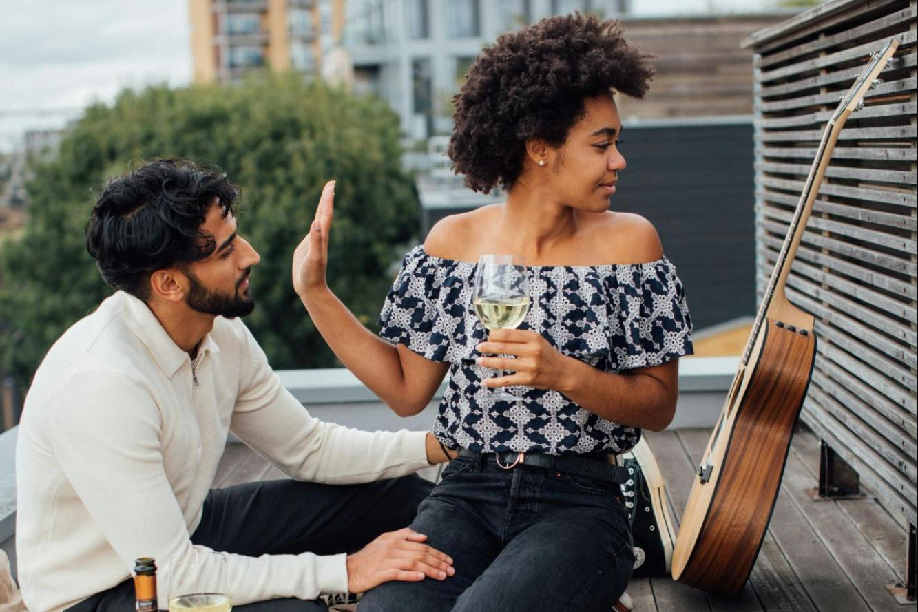woman putting up her hand to stop conversation on date