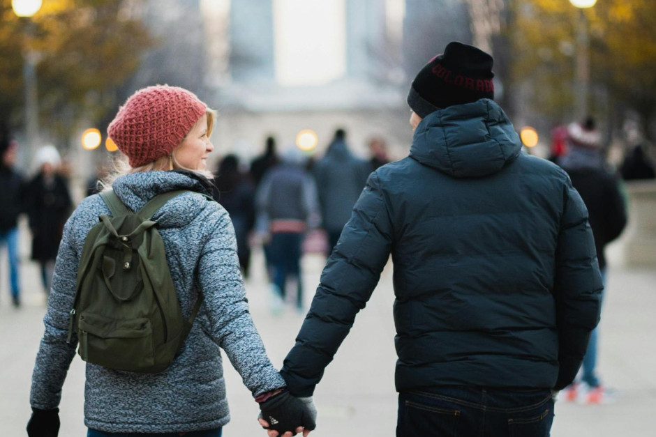 couple holding hands and walking in the park