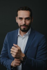 man in business suit, buckling arm buttons